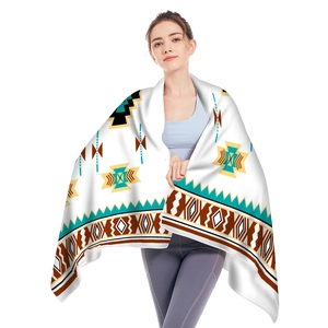 Detailed view of microfiber beach towel with ethnic geometric patterns worn as a shawl