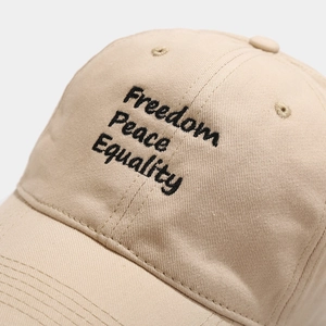 Beige cotton baseball cap featuring Freedom Peace Equality triple letter embroidery