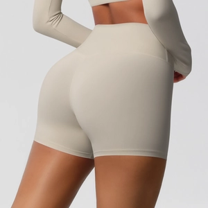 Detailed back view of high-waisted seamless peach lift yoga shorts in light beige