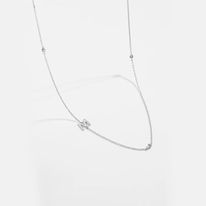 Silver clavicle necklace with M letter pendant and sparkling zircon stone accents