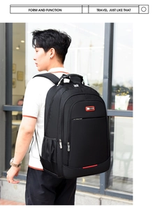 Close-up of a black travel backpack with reinforced handle and breathable back padding