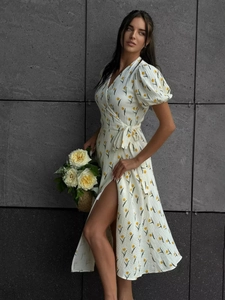 Detail of floral wrap dress with puff sleeves and yellow tulip print pattern