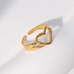 Detailed macro shot of the hollow heart-shaped open ring with polished gold finish