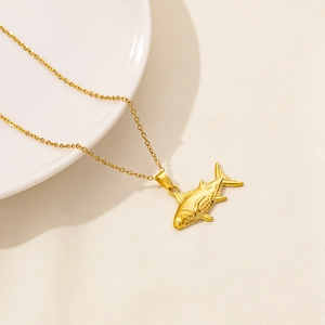Detailed macro view of 18K gold-plated tuna fish pendant with textured oceanic scales