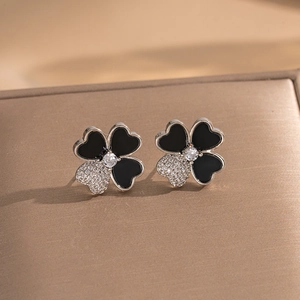 Elegant silver four-leaf clover stud earrings with black enamel and sparkling zircon stones