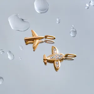 Mini airplane and flower pendants with cubic zirconia in 14K gold-plated stainless steel