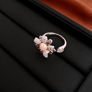 Macro detail of adjustable daisy ring with cubic zirconia micro-paving on black leather