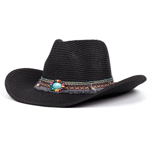 Detail of black linen Panama hat featuring colorful beads, turquoise stone, and tassel