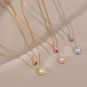 Detailed macro view of double-layer pendant necklaces with zircons in three finishes