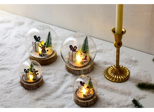 Close-up of Christmas glass snow globe with wooden base and warm LED lights
