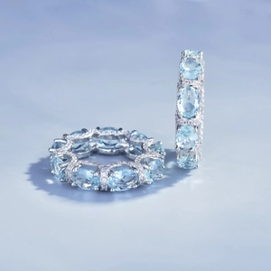 Silver rings with oval light blue gemstones and diamond accents in lace edge design