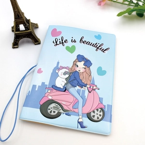 Close-up of light blue PU leather passport holder with cute cartoon girl on motorcycle