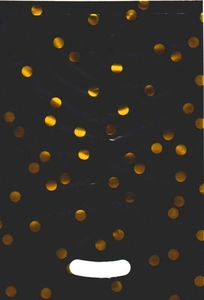 Macro shot of black plastic gift bag with gold foil polka dots and die-cut handle
