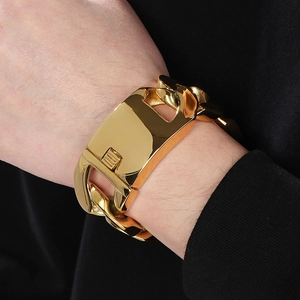 Close-up of a 30mm wide golden Cuban link bracelet on wrist with a large polished clasp