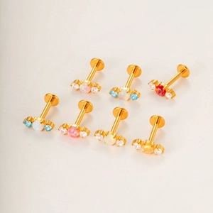 Titanium labret studs with colorful opal centers and zirconia accents in gold plating