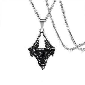 Macro view of vintage stainless steel Horus Eye winged pyramid pendant on box chain