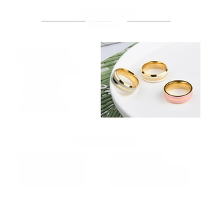 Detailed view of 7mm wide titanium steel rings with colored inlay and polished finish