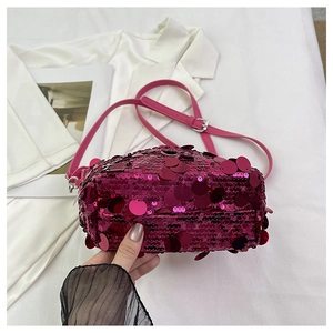 Detail of rose pink sequin handbag with adjustable leather strap and silver buckle