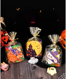 Detailed view of Halloween candy bags with castle, bear and rabbit prints with gold ties