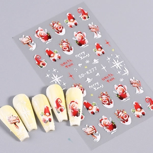 Detailed macro view of 5D embossed Christmas nail art stickers with Santa and reindeer motifs
