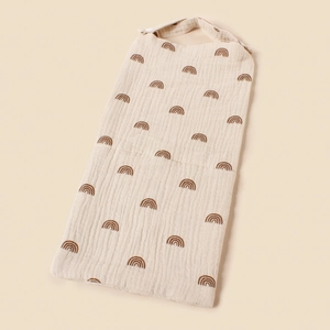 Close-up of cotton muslin baby crib storage bag featuring brown rainbow prints