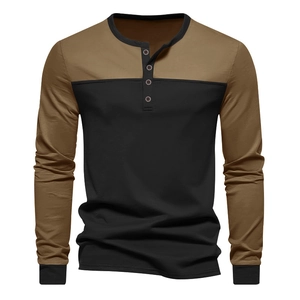 Detail of color-block long sleeve Henley shirt with button placket and ribbed cuffs