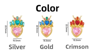 Detail view of heart-shaped crown pendants in gold and silver with pink gemstones