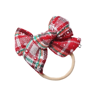 Red and green plaid Christmas bow headband with soft elastic nylon strap for infants