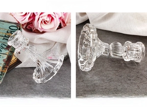 Detailed view of the clear glass candlestick holder with vertical embossed stripe textures