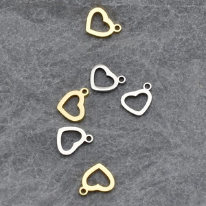 Close-up of heart-shaped hollow pendants in gold and silver finish for DIY jewelry