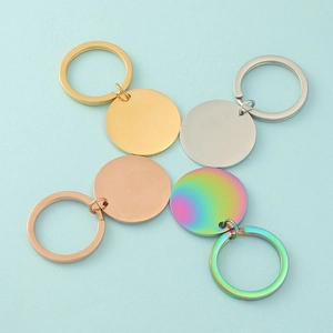 Macro detail of round stainless steel keychains in gold, silver, rose gold and rainbow