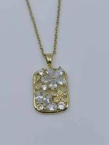 Macro detail of 18K gold plated titanium necklace with rectangular zircon flower pendant