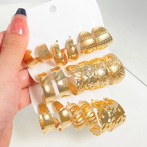 Three-piece set of textured gold C-shaped hoop earrings with a vintage metallic finish