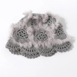 Detailed view of handmade crochet flower patterns and grey faux rabbit fur trim on knit hat