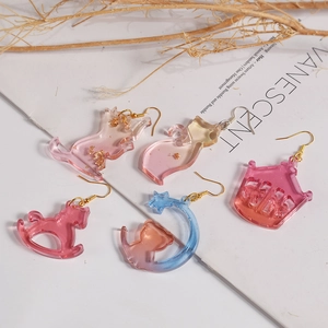 Handmade resin earrings set with gradient cat and castle charms and gold foil accents