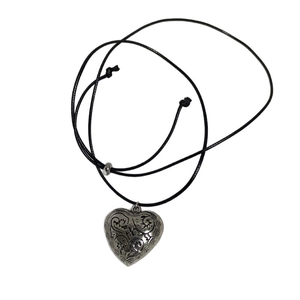 Bohemian style necklace with a vintage heart pendant and adjustable black wax cord