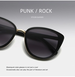 Macro shot of punk style black sunglasses with gold metal frame and rock logo detail
