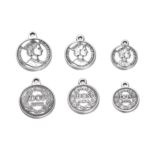 Detail of vintage silver alloy coin pendants in various sizes for DIY jewelry making