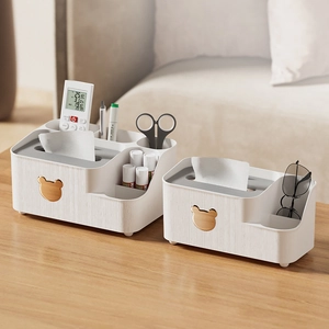Detailed view of Nordic tissue boxes with wood-textured lids and golden bear accents