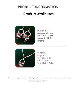 Detail view of butterfly necklace and earrings set with red stones and tennis chain