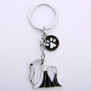 Detail of silver Yorkshire Terrier charm with black and white enamel and paw print tag