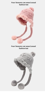 Detail of pink and gray knit earflap hats with faux fur trim and soft hanging pom-poms