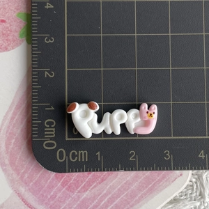 Detailed view of Puppy resin charm with cute dog ears and pink rabbit design for DIY crafts