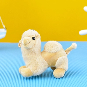 Close-up detail showing the soft texture of a cute light brown camel plush keychain charm