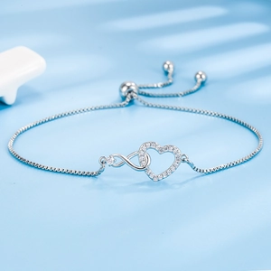Silver bracelet with heart and infinity symbols, sparkling zircons, and adjustable slide clasp