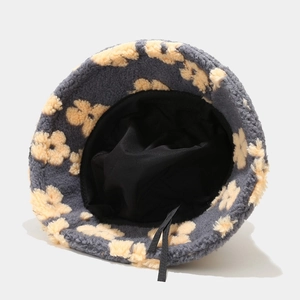 Gray plush bucket hat with beige flower patterns and inner lining with chin strap