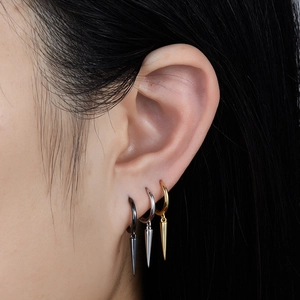 Three minimalist S925 silver spike earrings in black, silver and gold finish on model