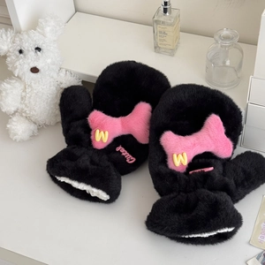Detail of plush black mittens with pink bone decor and thick warm lining on white desk