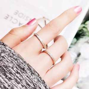 Set of two rose gold minimalist rings for women with frosted texture on finger