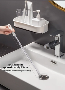 Macro view of 45cm flexible drain cleaner brush clearing bathroom sink pipes